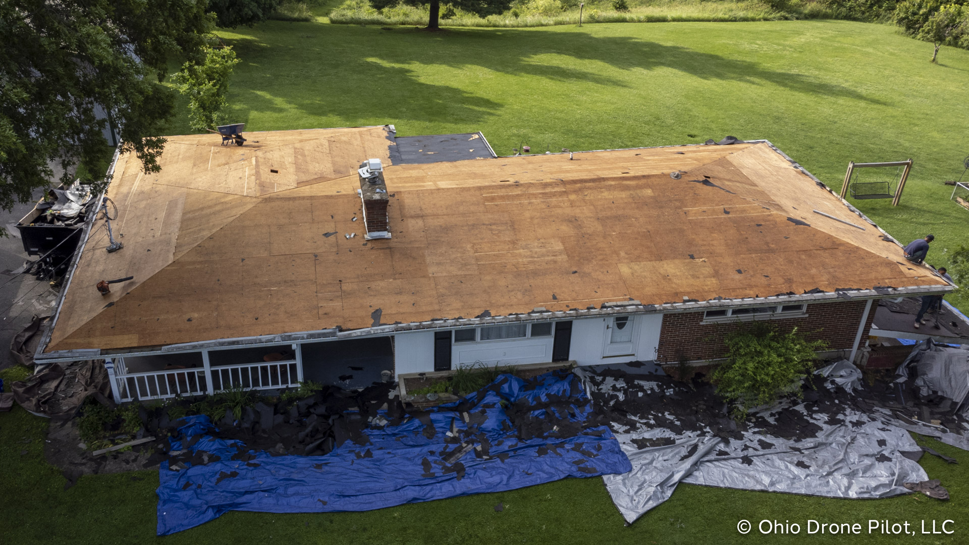 Front aerial view of a house with all of the roof stripped down to the wood, © Ohio Drone Pilot, LLC