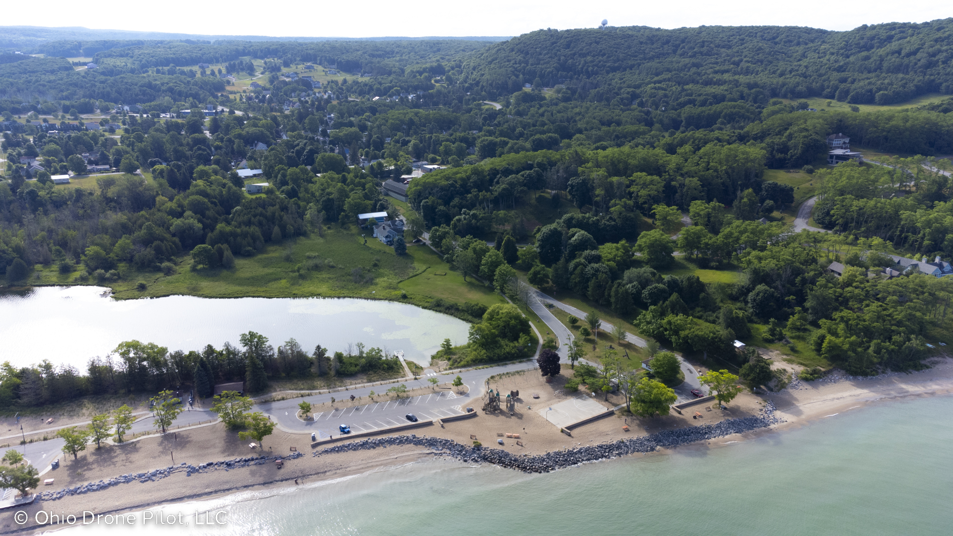 Arial photo over Lake Michigan looking back at Empire Beach with the village in the background