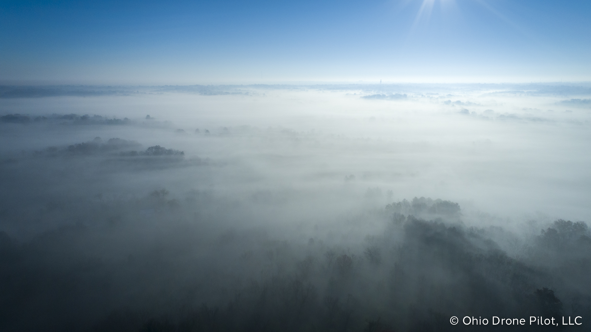 A layer of fog sits atop rolling residential hills of Colerain, Ohio