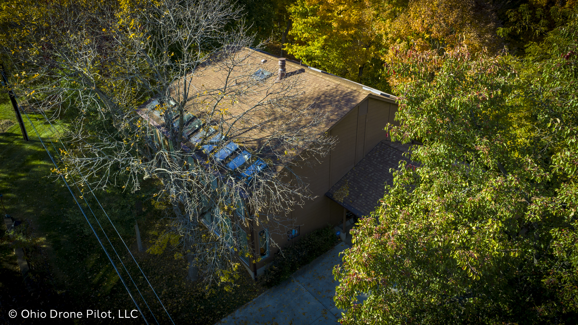 Aerial photo of a modern house set back into a wooded area