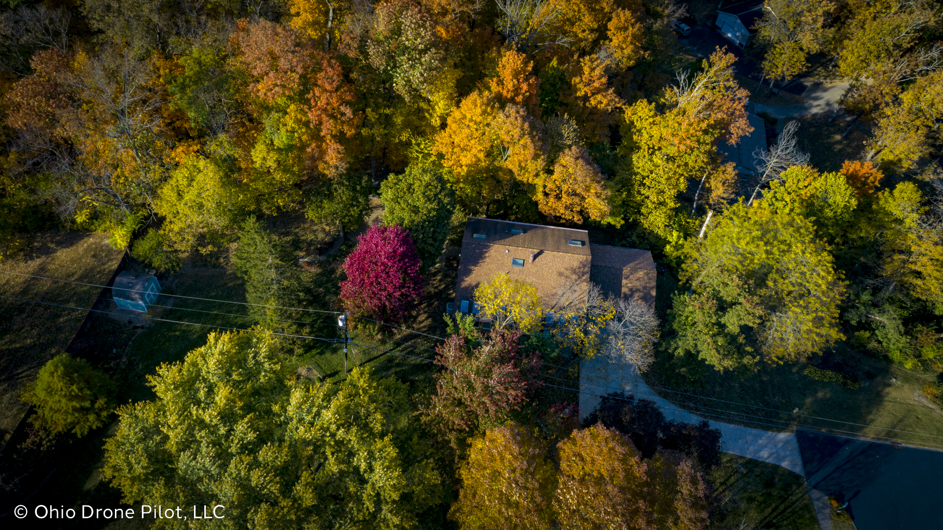 A high downward view of a modern home surrounded by woods