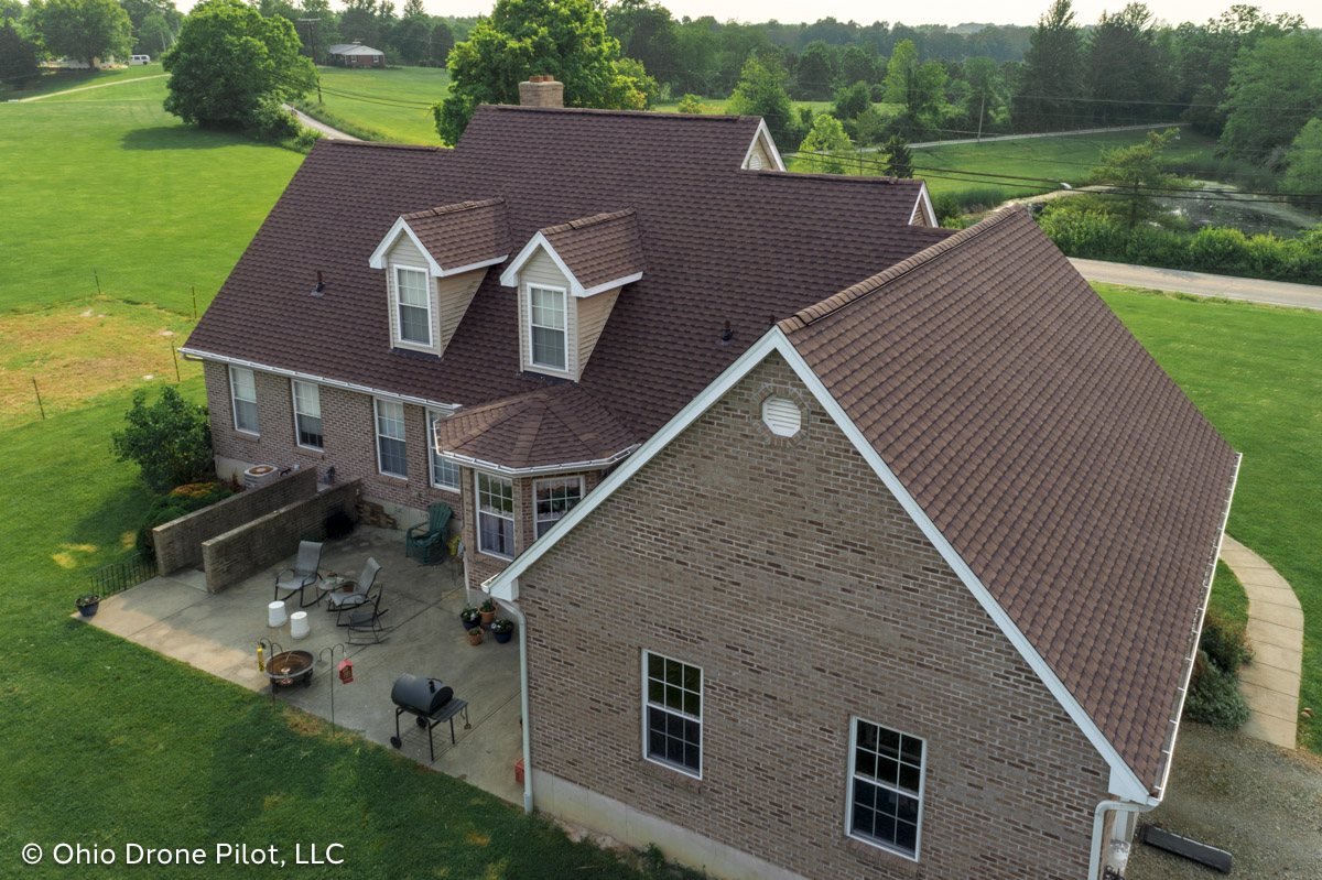 Aerial view looking at the rear side of a home with a newly installed roof