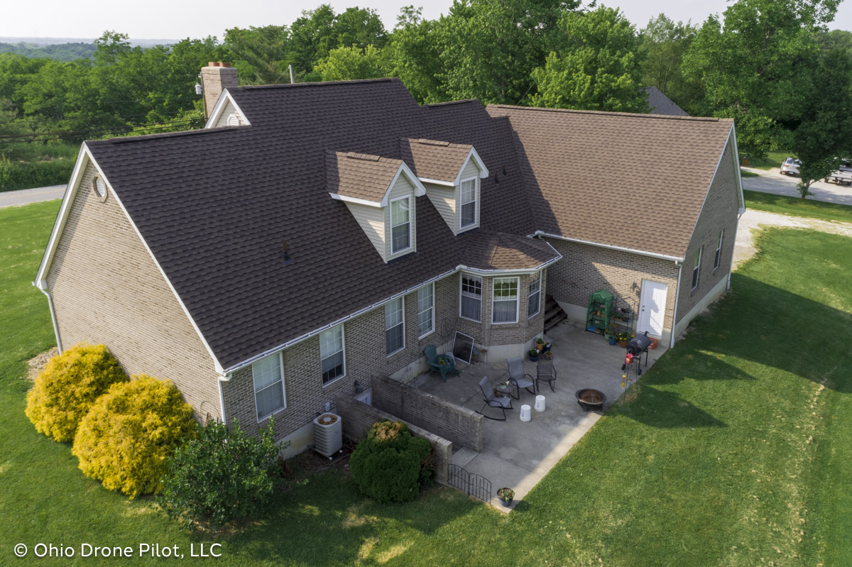 Long aerial view of a house with a newly installed roof