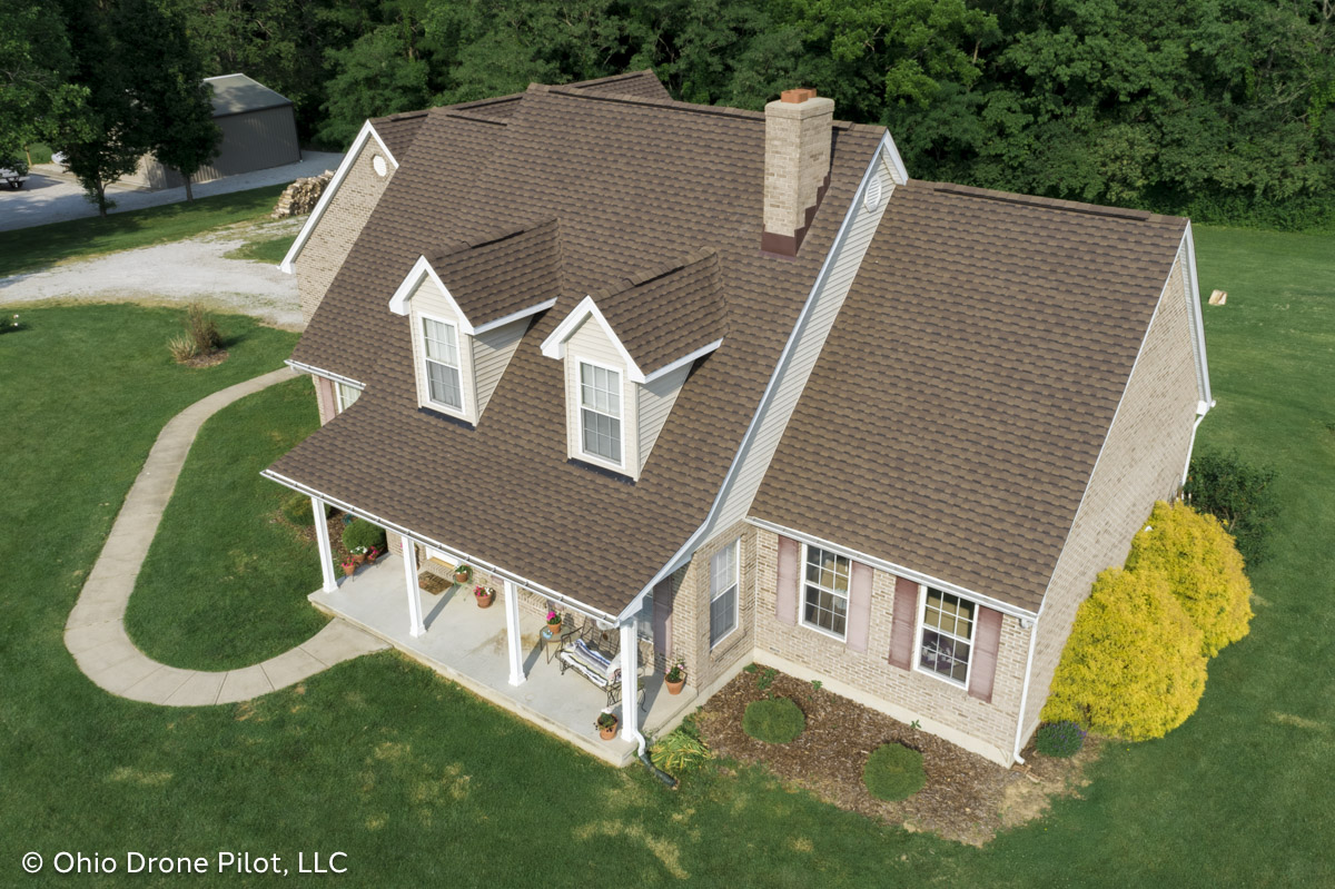 Front aerial view of a lovely Cape Cod with a newly installed roof