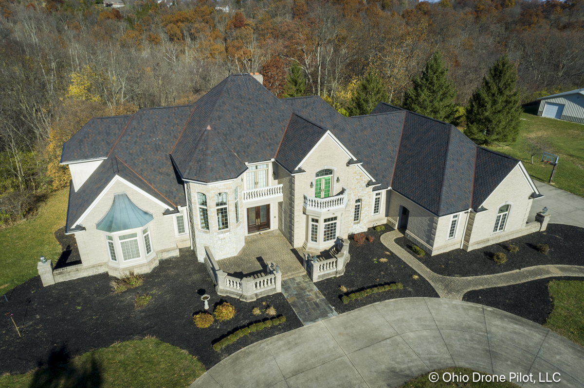 Looking down towards the front of a large home with a newly installed roof