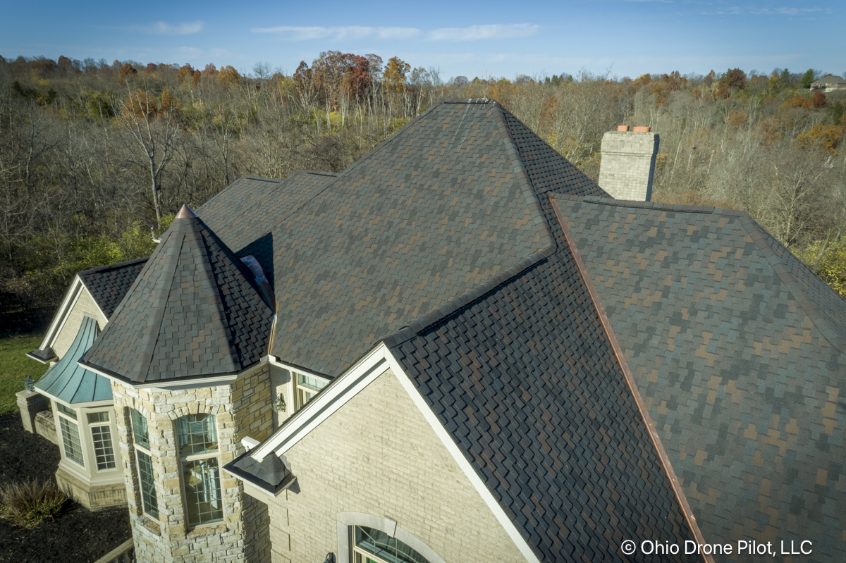 Closer aerial photo of a newly installed roof on a large home