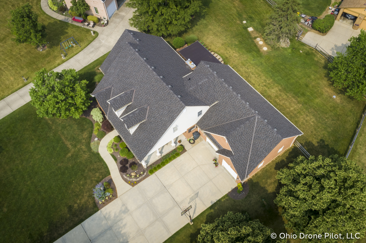 Aerial, downward view of a newly installed roof on a beautiful 2 story home. Photography by Ohio Drone Pilot, LLC