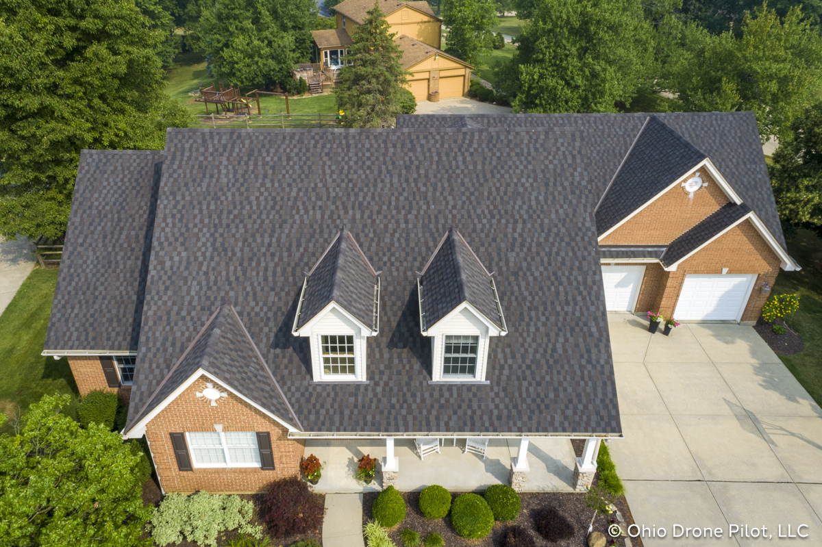 Aerial, downward view of a newly installed roof on a beautiful 2 story home. Photography by Ohio Drone Pilot, LLC