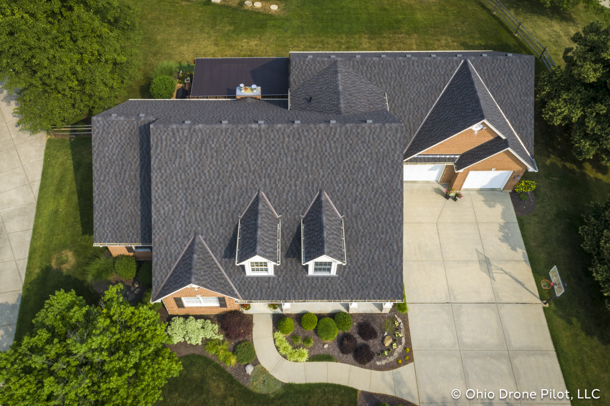 Aerial, downward view of a newly installed roof on a beautiful 2 story home. Photography by Ohio Drone Pilot, LLC