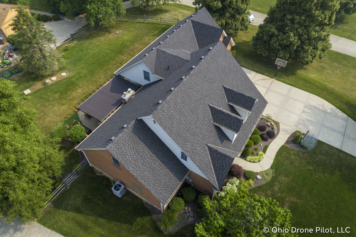 Aerial, downward view of a newly installed roof on a beautiful 2 story home. Photography by Ohio Drone Pilot, LLC