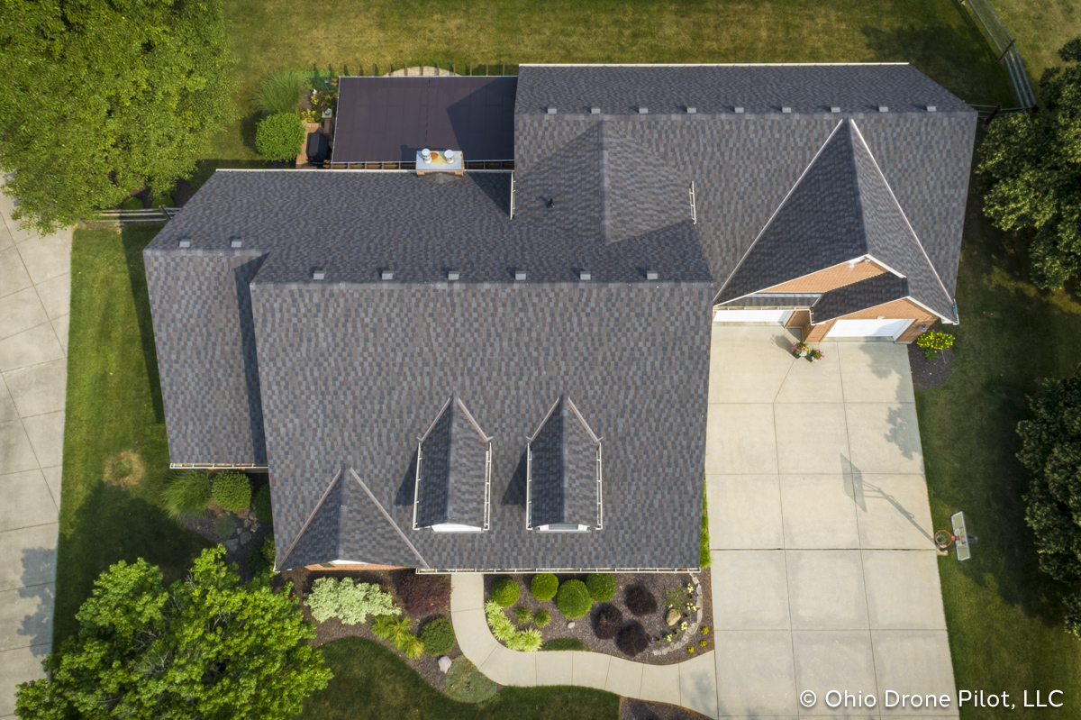 Aerial, downward view of a newly installed roof on a beautiful 2 story home. Photography by Ohio Drone Pilot, LLC